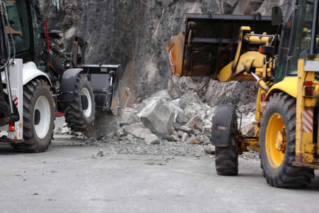 Baggers clean the aftermath of a stone landslide.の写真素材