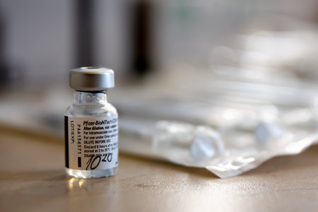 Sofia, Bulgaria - 20 January, 2021: A vial of the Pfizer-BioNTech vaccine against COVID-19 next to injections.のeditorial素材
