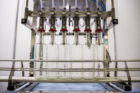 Automatic bottle filling machine for industrial use.