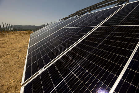 Solar panels are seen in a field.の写真素材