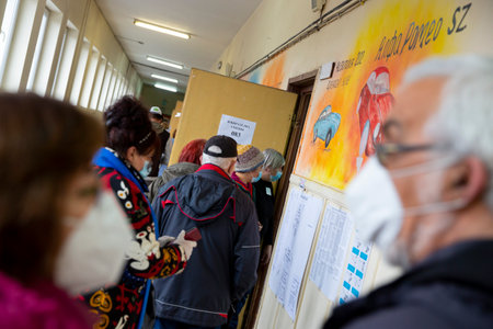 Sofia, Bulgaria: 4 April, 2021: People wait in line to cast their ballot at a polling station for the parliamentary elections.のeditorial素材