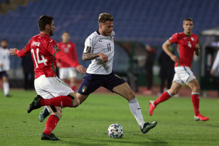 Sofia, Bulgaria - 27 March, 2021: Bulgaria's Daniel Dimov (L) in action with Italy's Ciro Immobile (C) during the FIFA World Cup 2022 qualifying soccer match between Bulgaria and Italy.のeditorial素材