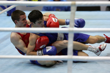 Sofia, Bulgaria - 26 February, 2021: Dorin Bucsa (red) of Moldova and Biibars Zheksen of Kazakhstan fight in their semifinal round of Feather (57kg) category of the 72-nd International Boxing Tournament "Strandja" 2021.のeditorial素材