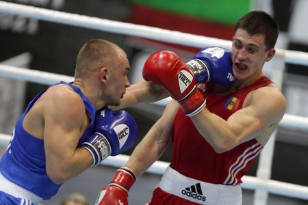 Sofia, Bulgaria - 26 February, 2021: Dmitri Galagot (red) of Moldova and Yevhenii Barabanov of Ukraine fight in their semifinal round of Welter (69kg) category of the 72-nd International Boxing Tournament "Strandja" 2021.のeditorial素材