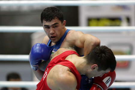 Sofia, Bulgaria - 26 February, 2021: Kots Maxim (red) of Ukraine and Dilshodbek Ruzmetov of Uzbekistan fight in their semifinal round of Light Heavy (81kg)category of the 72-nd International Boxing Tournament "Strandja" 2021.のeditorial素材