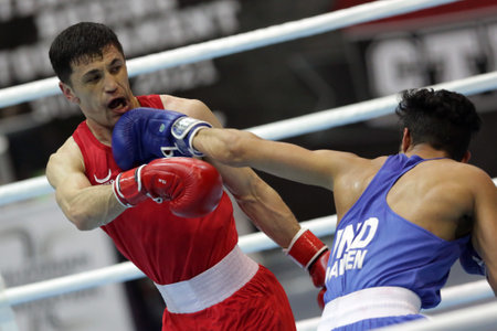 Sofia, Bulgaria - 26 February, 2021: Bobo-Usmon Baturov (red) of Uzbekistan and Naveen Boora of India fight in their semifinal round of Welter (69kg) category of the 72-nd International Boxing Tournament "Strandja" 2021.のeditorial素材
