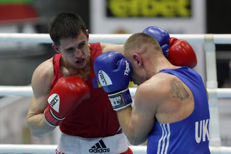 Sofia, Bulgaria - 26 February, 2021: Dmitri Galagot (red) of Moldova and Yevhenii Barabanov of Ukraine fight in their semifinal round of Welter (69kg) category of the 72-nd International Boxing Tournament "Strandja" 2021.のeditorial素材