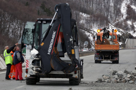 Sofia, Bulgaria - 31 January, 2021: Workers clean the aftermath of a stone landslide at the eighth kilometer of Struma Motorway.のeditorial素材