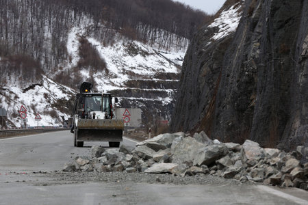 Sofia, Bulgaria - 31 January, 2021: Workers clean the aftermath of a stone landslide at the eighth kilometer of Struma Motorway.のeditorial素材