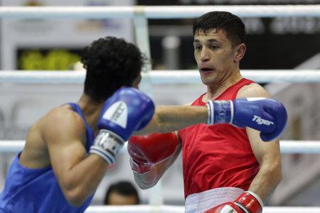 Sofia, Bulgaria - 26 February, 2021: Bobo-Usmon Baturov (red) of Uzbekistan and Naveen Boora of India fight in their semifinal round of Welter (69kg) category of the 72-nd International Boxing Tournament "Strandja" 2021.のeditorial素材