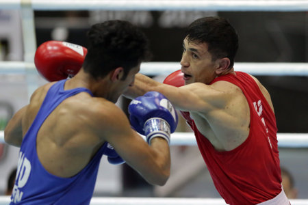 Sofia, Bulgaria - 26 February, 2021: Bobo-Usmon Baturov (red) of Uzbekistan and Naveen Boora of India fight in their semifinal round of Welter (69kg) category of the 72-nd International Boxing Tournament "Strandja" 2021.のeditorial素材