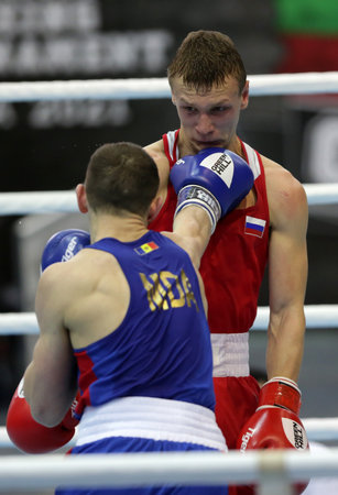 Sofia, Bulgaria. 27th February, 2021. Ilia Popov (red) of Russia and 
Alexandru Paraschiv of Moldova fight in their final round of Light (63kg) category of the 72-nd International Boxing Tournament "Strandja" 2021.のeditorial素材