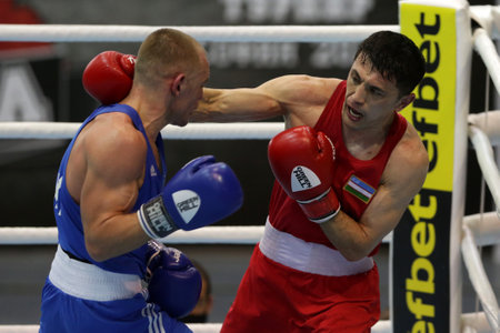 Sofia, Bulgaria. 27th February, 2021. Bobo-Usmon Baturov (red) of Uzbekistan and Yevhenii Barabanov of Ukraine fight in their final round of Welter (69kg) category of the 72-nd International Boxing Tournament "Strandja" 2021.のeditorial素材