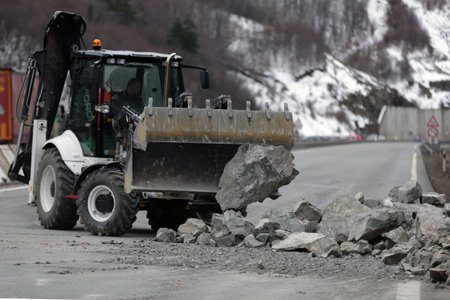 Sofia, Bulgaria - 31 January, 2021: Workers clean the aftermath of a stone landslide at the eighth kilometer of Struma Motorway.のeditorial素材
