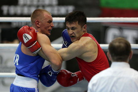 Sofia, Bulgaria. 27th February, 2021. Bobo-Usmon Baturov (red) of Uzbekistan and Yevhenii Barabanov of Ukraine fight in their final round of Welter (69kg) category of the 72-nd International Boxing Tournament "Strandja" 2021.のeditorial素材