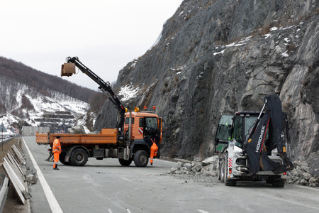 Sofia, Bulgaria - 31 January, 2021: Workers clean the aftermath of a stone landslide at the eighth kilometer of Struma Motorway.のeditorial素材