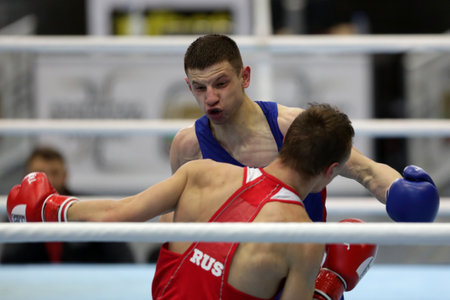 Sofia, Bulgaria. 27th February, 2021. Ilia Popov (red) of Russia and 
Alexandru Paraschiv of Moldova fight in their final round of Light (63kg) category of the 72-nd International Boxing Tournament "Strandja" 2021.のeditorial素材