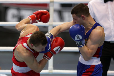Sofia, Bulgaria. 27th February, 2021. Ilia Popov (red) of Russia and 
Alexandru Paraschiv of Moldova fight in their final round of Light (63kg) category of the 72-nd International Boxing Tournament "Strandja" 2021.のeditorial素材
