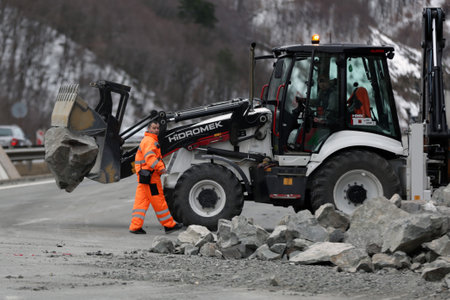 Sofia, Bulgaria - 31 January, 2021: Workers clean the aftermath of a stone landslide at the eighth kilometer of Struma Motorway.のeditorial素材