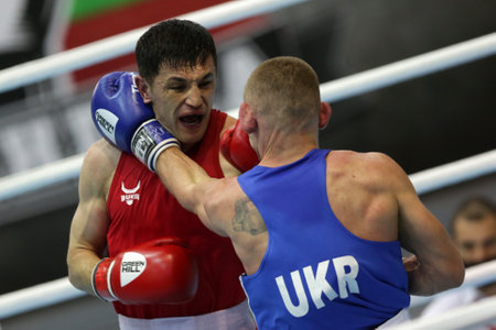 Sofia, Bulgaria. 27th February, 2021. Bobo-Usmon Baturov (red) of Uzbekistan and Yevhenii Barabanov of Ukraine fight in their final round of Welter (69kg) category of the 72-nd International Boxing Tournament "Strandja" 2021.のeditorial素材