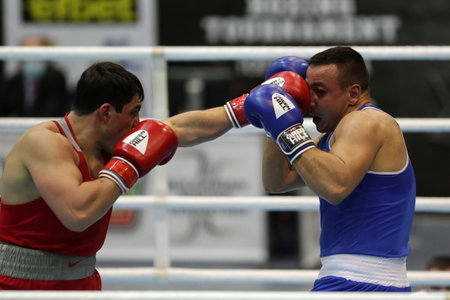 Sofia, Bulgaria. 27th February, 2021. Narek Manasyan (red) of Armenia and Radoslav Pantaleev of Bulgaria fight in their final round of Heavy (91kg) category of the 72-nd International Boxing Tournament "Strandja" 2021.のeditorial素材