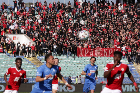 Sofia, Bulgaria: 25 April, 2021: CSKA Sofia's supporters cheer their team during the national championship football match between Levski and CSKA Sofia. Football fans have been allowed to attend the stadium with less than 30% of the seats amidst the coronのeditorial素材