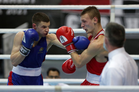 Sofia, Bulgaria. 27th February, 2021. Ilia Popov (red) of Russia and Alexandru Paraschiv of Moldova fight in their final round of Light (63kg) category of the 72-nd International Boxing Tournament "Strandja" 2021.のeditorial素材