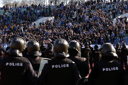 Sofia, Bulgaria: 25 April, 2021: Riot policemen stand in front of supporters after clashes during the national championship football match between Levski and CSKA Sofia. Football fans have been allowed to attend the stadium with less than 30% of the seatsのeditorial素材