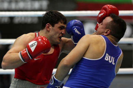 Sofia, Bulgaria. 27th February, 2021. Narek Manasyan (red) of Armenia and Radoslav Pantaleev of Bulgaria fight in their final round of Heavy (91kg) category of the 72-nd International Boxing Tournament "Strandja" 2021.のeditorial素材
