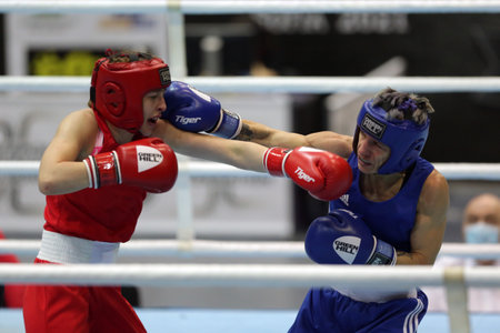 Sofia, Bulgaria - 26 February, 2021: Angelina Lukas (red) of Kazakhstan and Lacramioara Perijoc of Romania fight in their semifinal round of Fly (W51kg) category of the 72-nd International Boxing Tournament "Strandja" 2021.のeditorial素材