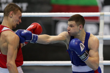 Sofia, Bulgaria. 27th February, 2021. Ilia Popov (red) of Russia and 
Alexandru Paraschiv of Moldova fight in their final round of Light (63kg) category of the 72-nd International Boxing Tournament "Strandja" 2021.のeditorial素材