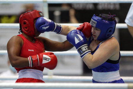 Sofia, Bulgaria - 26 February, 2021: Possantos Perejra (red) of Brazil and Nadezhda Ryabets of Kazakhstan fight in their semifinal round of Middle (W75kg) category of the 72-nd International Boxing Tournament "Strandja" 2021.のeditorial素材