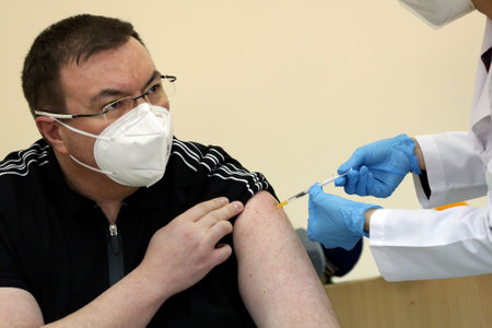 Sofia, Bulgaria - 18 January, 2021: Bulgarian Minister of Health Kostadin Angelov receives the second dose of Pfizer-BioNTech vaccine against COVID-19 at Aleksandrovska University Hospital.のeditorial素材