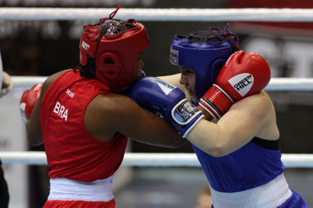 Sofia, Bulgaria - 26 February, 2021: Possantos Perejra (red) of Brazil and Nadezhda Ryabets of Kazakhstan fight in their semifinal round of Middle (W75kg) category of the 72-nd International Boxing Tournament "Strandja" 2021.のeditorial素材