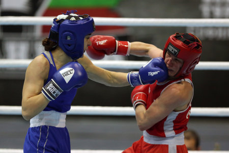 Sofia, Bulgaria - 26 February, 2021: Mira Potkonen (red) of Finland and Karina Ibragimova of Kazakhstan fight in their semifinal round of Light Welter (W60kg) category of the 72-nd International Boxing Tournament "Strandja" 2021.のeditorial素材