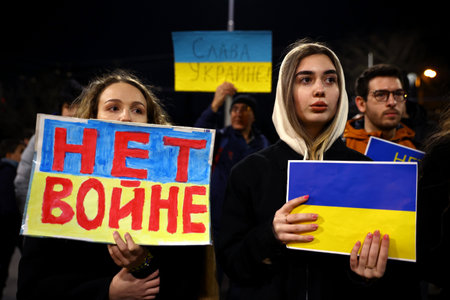 Sofia, Bulgaria - 24 March, 2022: Young women react as they hold protest signs during a demonstration in support of Ukraine one month after Russia's invasion of the country.のeditorial素材