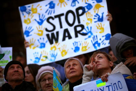 Sofia, Bulgaria - 24 March, 2022: A woman reacts as she holds a protest sign during a demonstration in support of Ukraine one month after Russia's invasion of the country.のeditorial素材