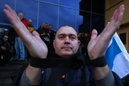 Sofia, Bulgaria - 7 April, 2022: A man demonstrates with tied arms in front of the Russian cultural and information center during a march in support of Ukraine. On 24th of February Russian army entered Ukrainian territory in what the Russian president Vlaのeditorial素材