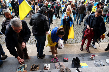 Sofia, Bulgaria - 7 April, 2022: People leave shoes on the stairs in front of the Russian cultural and information center during a demonstration in support of Ukraine. On 24th of February Russian army entered Ukrainian territory in what the Russian presidのeditorial素材