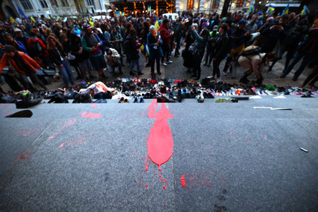 Sofia, Bulgaria - 7 April, 2022: Red paint is seen near left shoes on the stairs in front of the Russian cultural and information center during a demonstration in support of Ukraine. On 24th of February Russian army entered Ukrainian territory in what theのeditorial素材