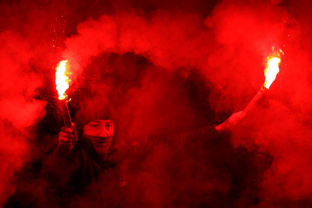 Sofia, Bulgaria - 21 April, 2022: A fan of CSKA-Sofia lights red flares during a football match between PFC CSKA-Sofia and PFC Slavia.のeditorial素材