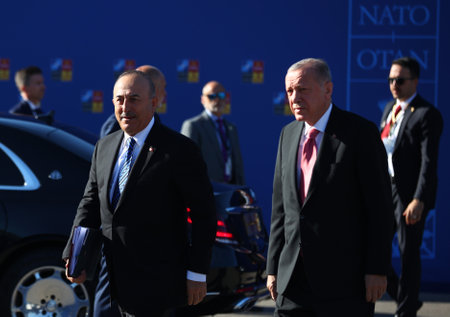 Spain, Madrid - 29 June, 2022: Turkish President Recep Tayyip Erdogan (R) and Turkish Foreign Minister Mevlut Cavusoglu attend the NATO summit in Madrid, Spain.のeditorial素材