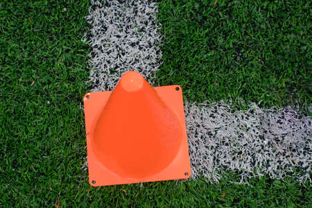 orange cone on turf fieldの写真素材