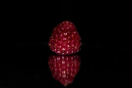 Raspberry closeup. Isolated on black. Selective focus.の写真素材