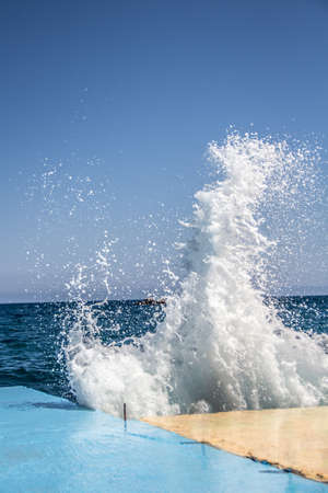 Waves breaking on a concrete pier in windy weather 2.の写真素材