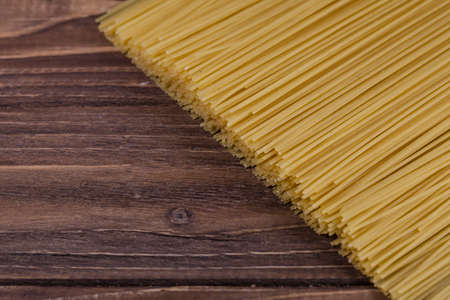 Uncooked spaghetti lie on a diagonal directionの写真素材