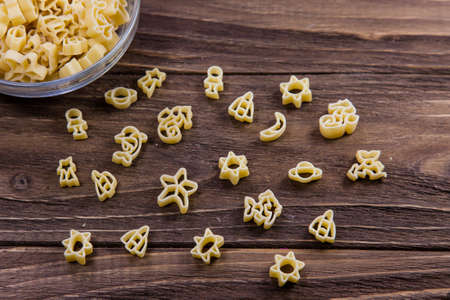 Raw macaroni on an old wooden table. Mix pasta. Close upの写真素材
