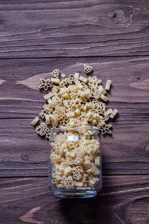 Raw macaroni, spaghetti on an old wooden table. Mix of pasta.の写真素材