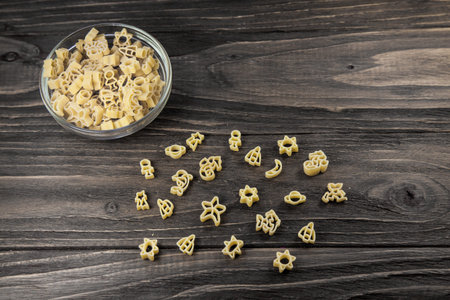 Raw macaroni on an old wooden table. Mix pasta. Background