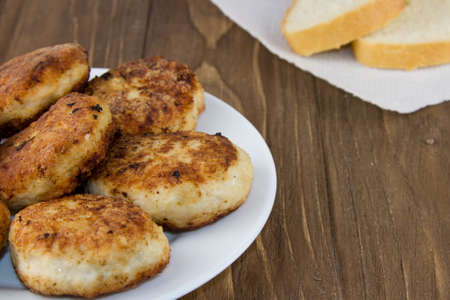 Fresh meat cutlet in plate isolated on a wooden background. Close upの写真素材